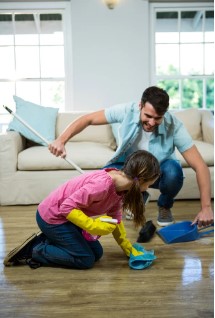Daughter-helping-father-to-clean-floor-at-home